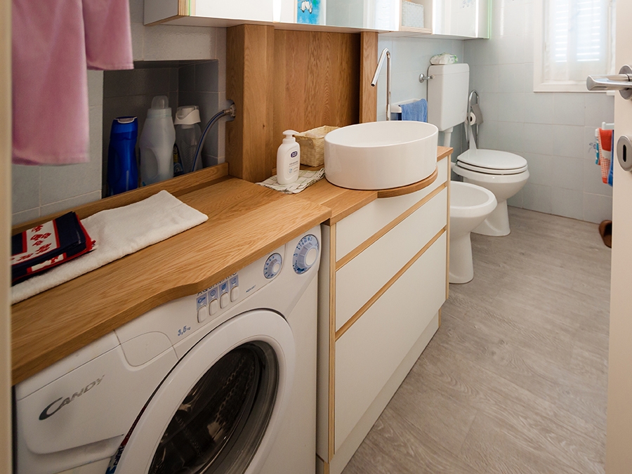 bathroom with washing machine in view