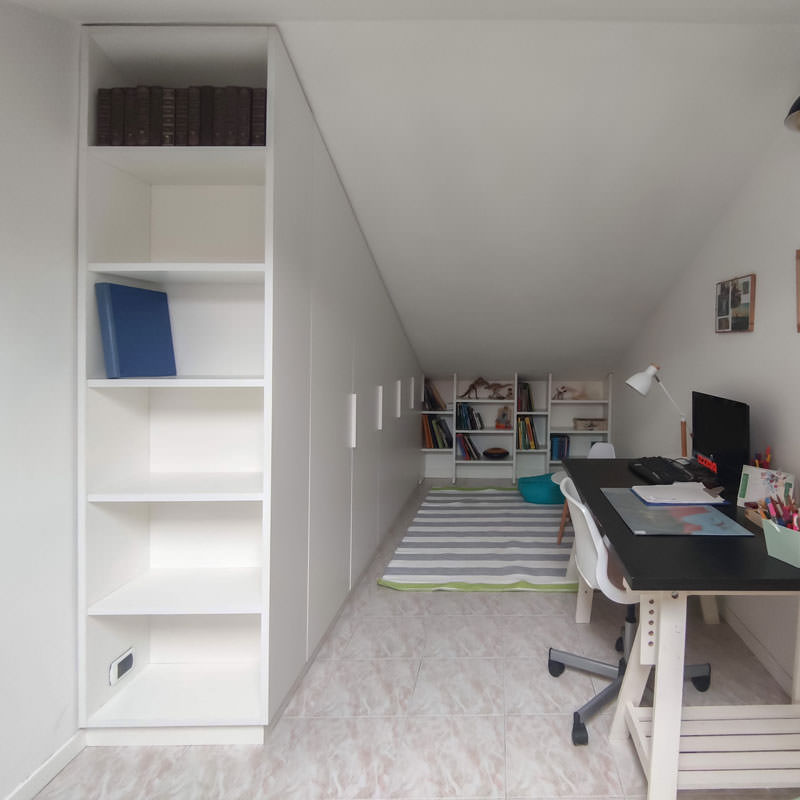 A bespoke wardrobe in the attic: sloping doors and large bookcases