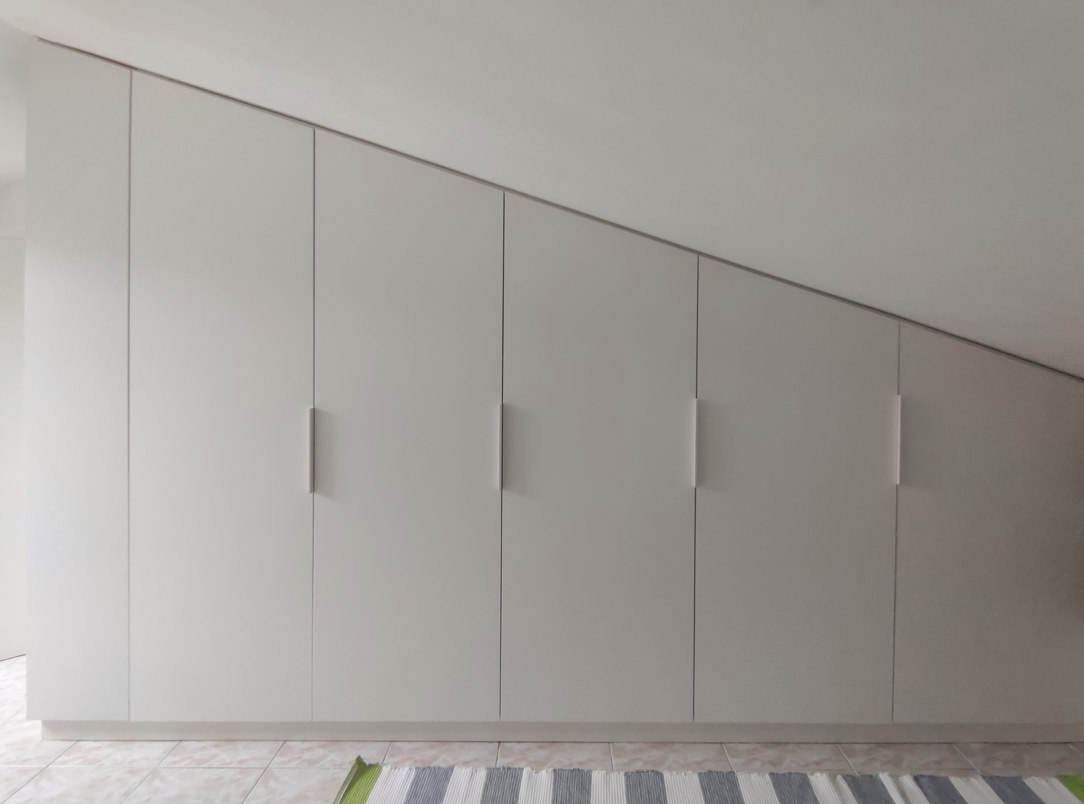 bespoke wardrobe attic sloping ceiling bookcase in front of sloping doors