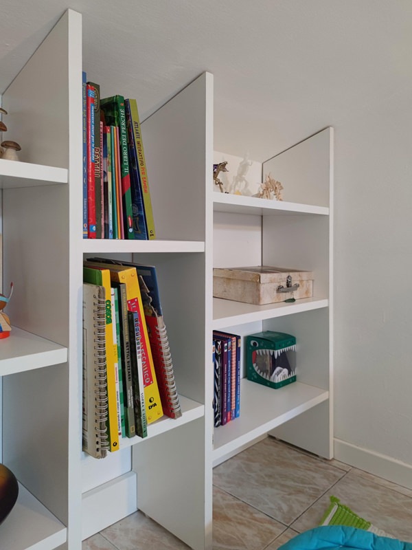 detail of white bilaminate bookcase shelves