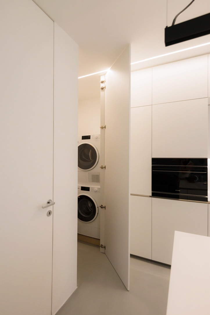 white kitchen with laundry corner island