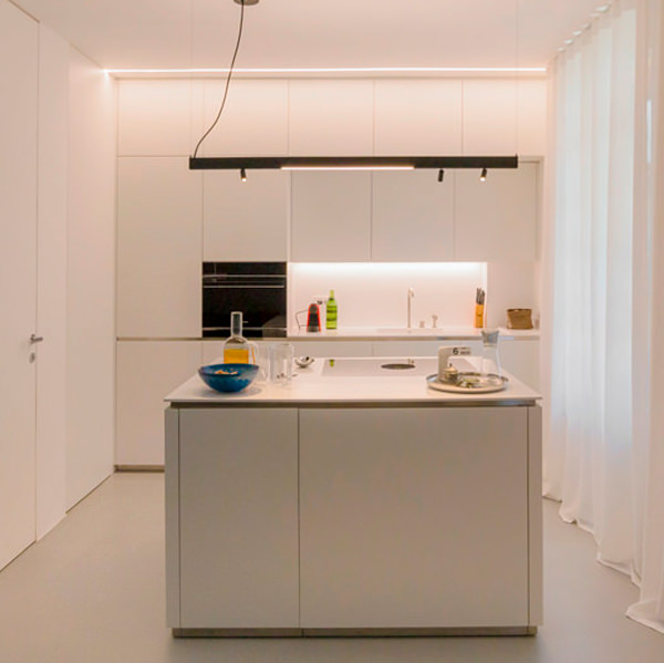 When a white kitchen with an island becomes a functional element of a youthful two-room apartment