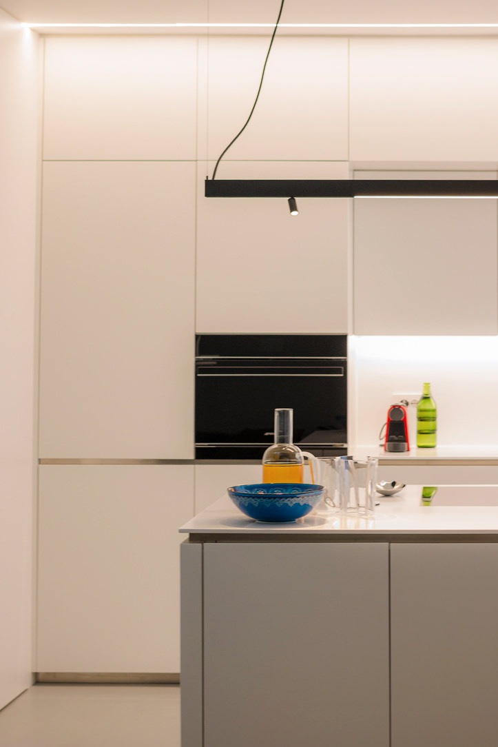 white kitchen with island oven combination column